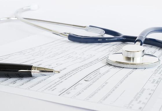 medical paperwork with a pen and a stethoscope in a clinical setting related to health care and five important assessments