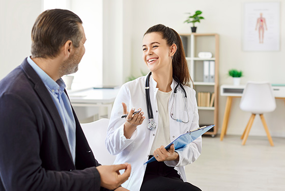 doctor consulting patient smiling in modern clinic discussing health with five important questions about wellbeing